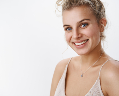 sincere-delighted-feminine-blond-girl-with-blue-eyes-nice-happy-smile-gazing-camera-giggling-having-fun-laughing-enjoying-evening-posing-satisfied-cheerful-tender-pose-white-wall